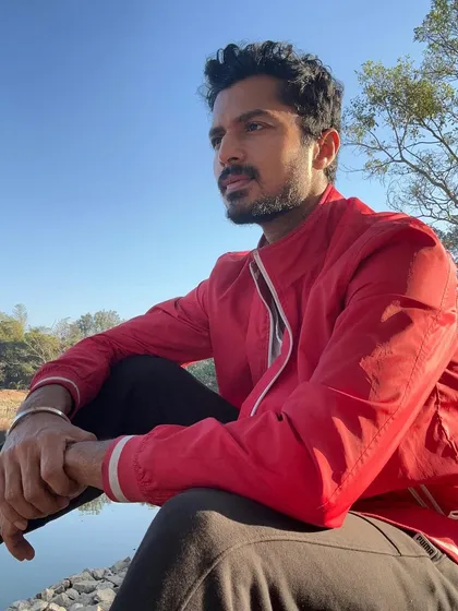 Enjoying a quiet moment by the lake. This shows my love for nature and a more contemplative side.