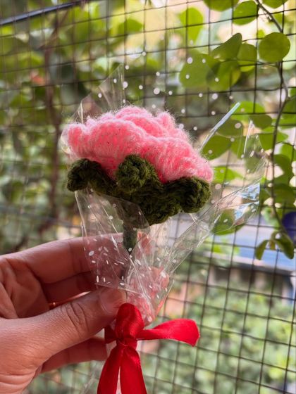 A single pink crochet rose, beautifully wrapped and ready to be gifted. It's a perfect token of appreciation.