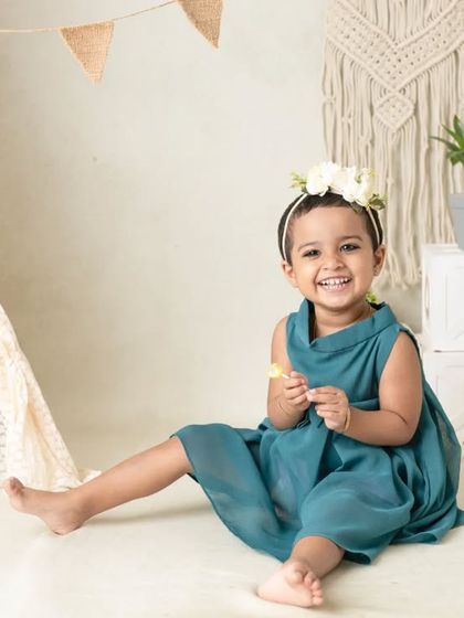 My boho-themed sessions use natural textures like macrame, wood, and greenery to create a calm and earthy setting that beautifully complements your child's simple joy.