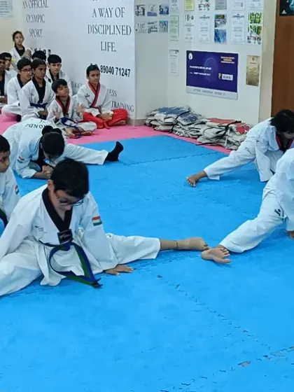 Students demonstrating excellent form and dedication during flexibility training.