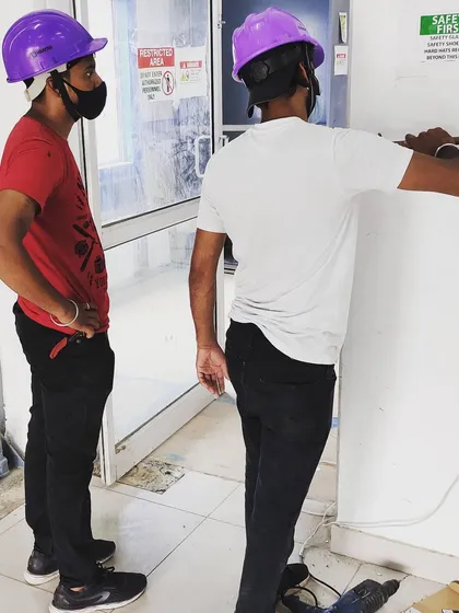 Our team works together on-site to plan and execute the installation. Here, our technicians are preparing the entry point for a new access control unit, ensuring all wiring and placement is optimized for performance and aesthetics.