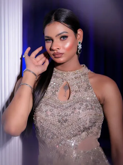 A bold and beautiful portrait of a model in a beige sequined gown, looking confidently at the camera.