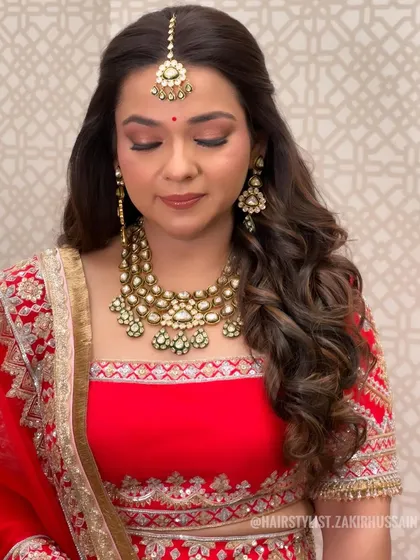 A classic half-up style with soft waves, perfect for a traditional wedding look.