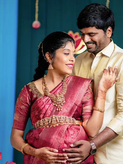 We guide our clients into comfortable, natural poses that highlight their connection. This couple shares a gentle moment during their indoor baby shower photoshoot, surrounded by festive decor.