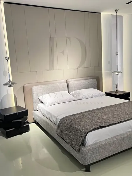 A complete bedroom set designed for a modern, serene paradise. The bed features a two-material headboard, paired with unique, sculptural black side tables and sleek pendant lighting.