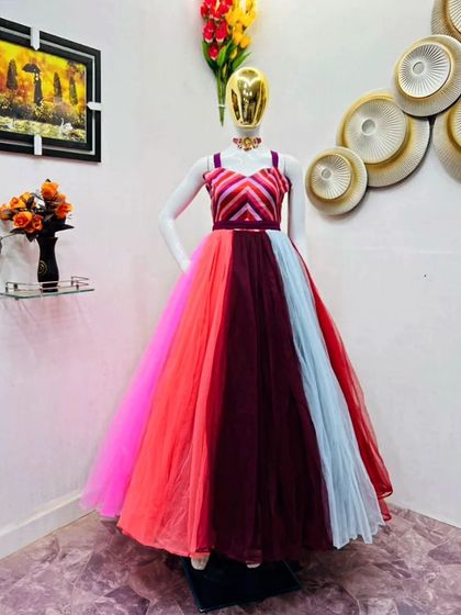 A modern and colorful gown with a chevron-patterned bodice and a multi-tonal skirt. This is a unique and eye-catching dress available for rent.