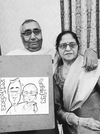 A lovely couple holding their caricature from an engagement party. It's a wonderful keepsake to remember the special day.