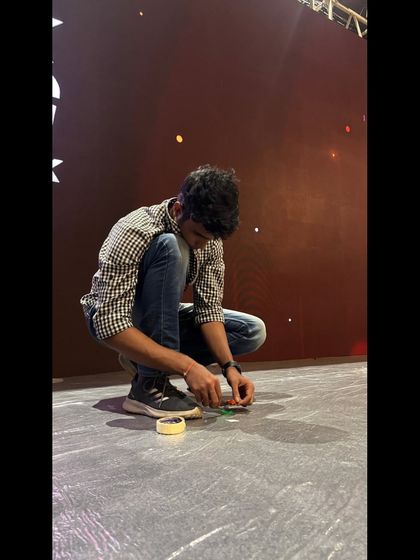 A team member carefully placing stage markers. This attention to detail ensures every element is perfectly positioned for the show.