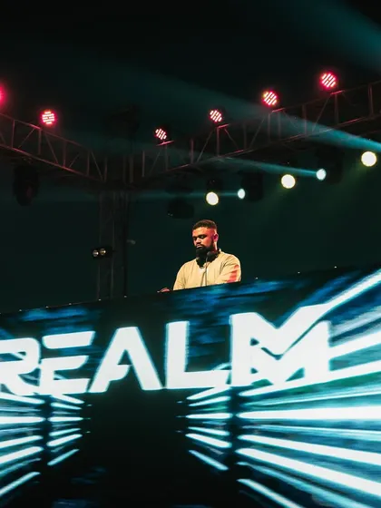 A shot of me on a large festival stage with my name lit up on the console. This is about brand presence and delivering a headline-worthy performance, no matter the time slot.