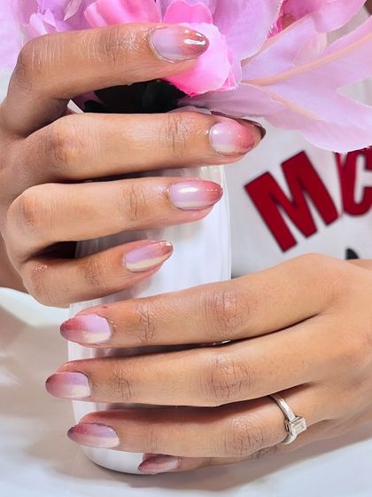 A beautiful close-up of ombre chrome nails, showing the smooth transition of color.