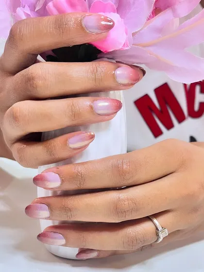 A beautiful close-up of ombre chrome nails, showing the smooth transition of color.