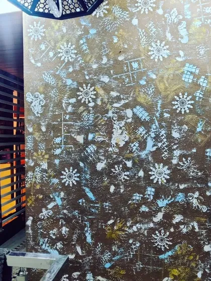 For a truly unique wall, I create custom artistic finishes. This accent wall features a multi layered design with abstract patterns and textures, creating a one of a kind piece of art for the home.