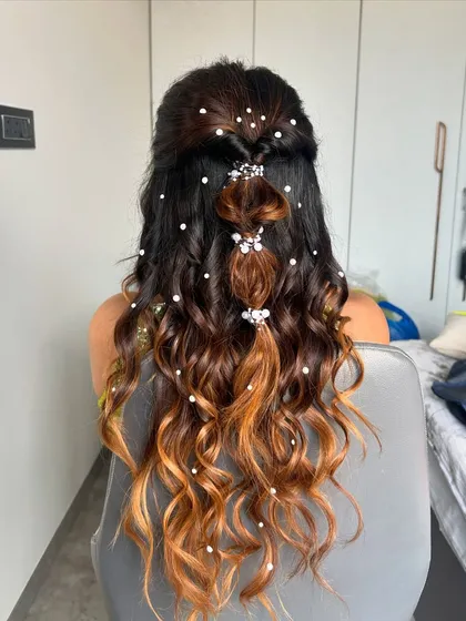 This playful bubble braid is one of my favorite hairstyles for a Sangeet or Mehendi. It's a trendy, Pinterest-worthy look, and I added delicate pearl accessories to make it extra special.