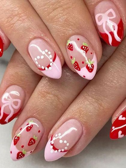 Getting your nails ready for a special date. This lovely Valentine's design features hand-painted strawberries, delicate bows, and heart patterns on a pink and red base.