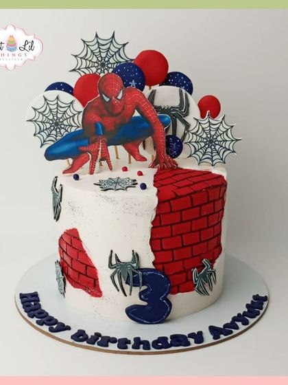 A Spider-Man cake for a 3rd birthday, featuring the superhero against a brick wall background.