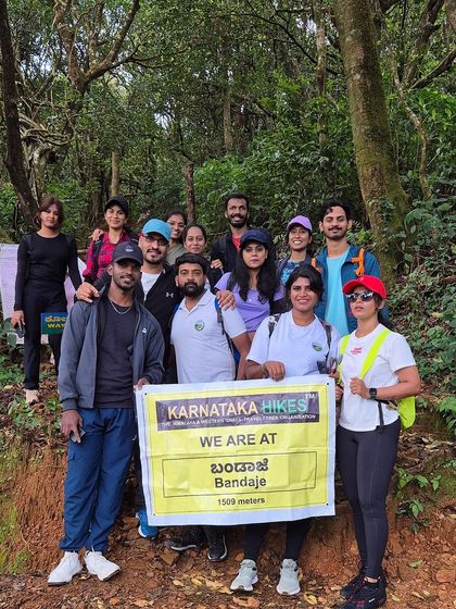 Our group at the start of the Bandaje trek, posing with our banner in the forest.