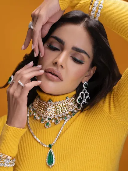 A close-up from our emerald jewelry campaign, focusing on the interplay between the green stones and the model's expression. The styling is rich and captivating.