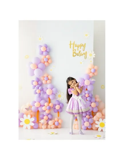 A charming pose from the birthday girl. The soft colors of the balloon flowers create a dreamy, celebratory atmosphere for her fifth birthday portraits.