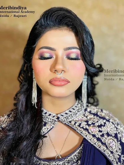 This is a perfect cocktail party look, featuring a dramatic, multi-tonal glittery eye and soft, wavy hair.