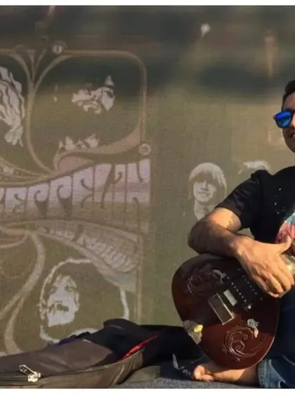 A relaxed moment during a soundcheck for a rock concert in Bangalore, with a Led Zeppelin backdrop. The sitar has a rich history in rock music that I love to explore.