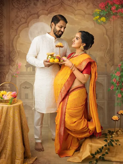 A beautiful portrait celebrating Sankranthi and new beginnings. The couple shares a tray of festive sweets in a setting that is rich with traditional details and the promise of their growing family.