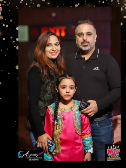 A young performer with her proud parents at the Aagaaz event. It's a night of celebration for the entire Hangin family.