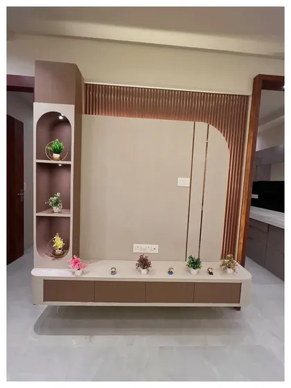 A simple yet elegant TV unit with a curved floating console in a two-tone finish. The fluted paneling on the back wall adds texture and visual interest, while the open shelves provide space for decor.