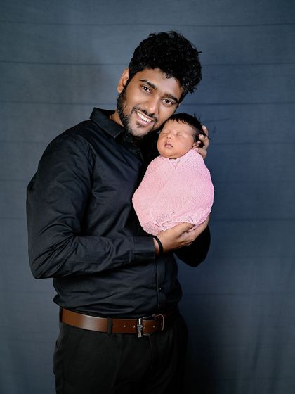 A duplicate of image 34, capturing the special bond between a father and his newborn.