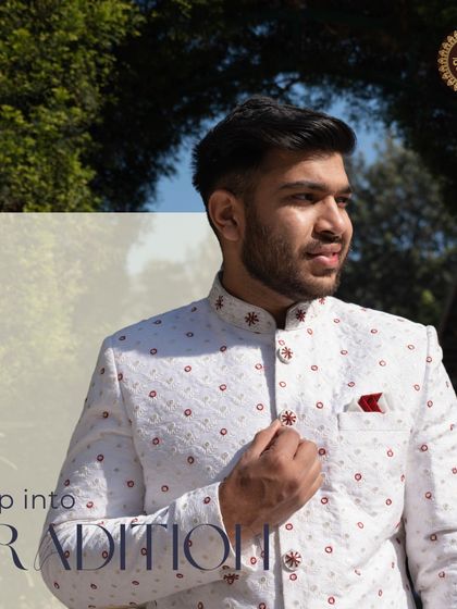 Step into tradition with this beautifully crafted white sherwani. The outdoor setting highlights its bright, clean aesthetic, perfect for a daytime ceremony.