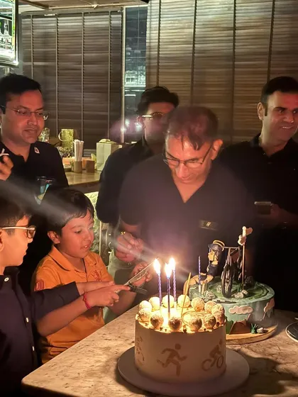 The kids get to help with the cake too! A wholesome moment from the birthday celebration.