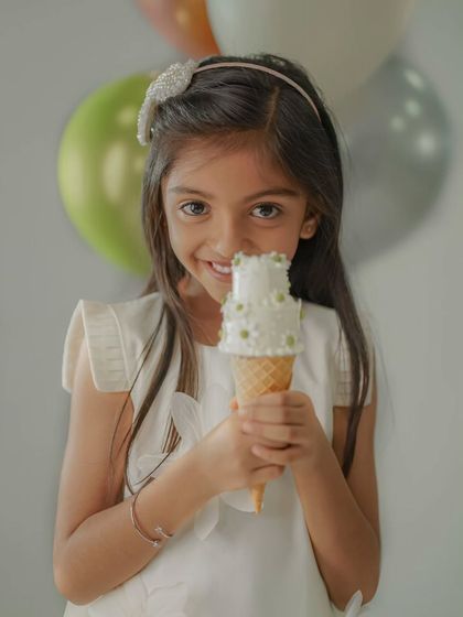 A sweet close-up of the birthday girl with a unique cake cone. I love capturing these small, happy details that make the photoshoot special.