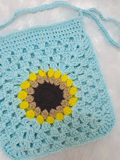 This sky blue sunflower sling bag is a lovely, soft color. It's a great everyday bag that's both practical and pretty, handmade by me with care.