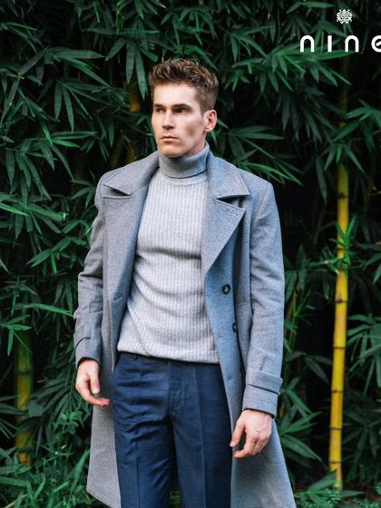 The overcoat worn open, revealing the polo neck sweater underneath. This shows the versatility of the piece for layering.