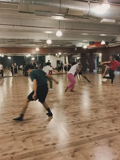 Dancers moving across the floor during a contemporary workshop. This image captures the dynamic and spacious environment of our studios.
