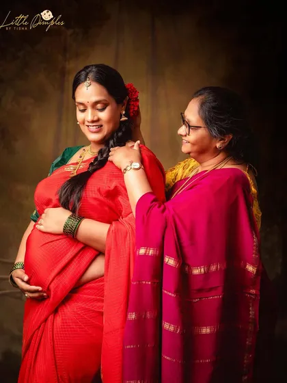 A close-up of the tender moment between a mother and her expecting daughter, a beautiful addition to any maternity photo album.