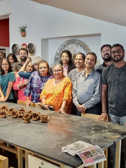 The proud creators and their clay monsters. This group photo captures the sense of accomplishment and fun from our team-building workshop.