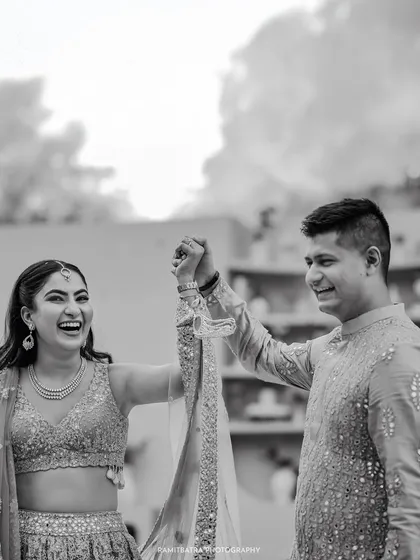 A joyous black and white shot of the couple celebrating after their engagement ceremony.