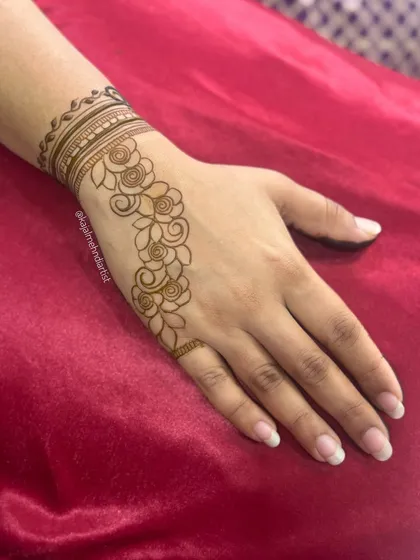 A simple and elegant floral vine design, perfect for someone who wants a touch of henna without full coverage.