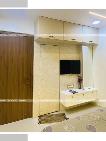 A view of the master bedroom showing the integrated TV and dressing unit. This space-saving design keeps the room looking organized and spacious.