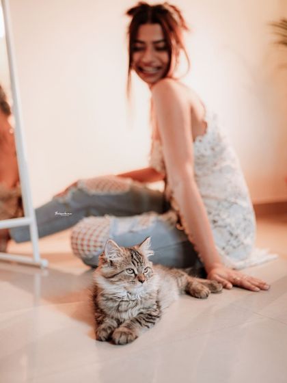 Adding a pet to the shoot created a moment of pure joy. This lifestyle shot feels authentic and heartwarming, showing a different side of the model's personality.