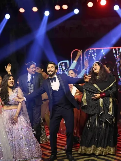 The whole family on stage. We love organizing group performances that bring everyone together for a fun and memorable Sangeet dance.