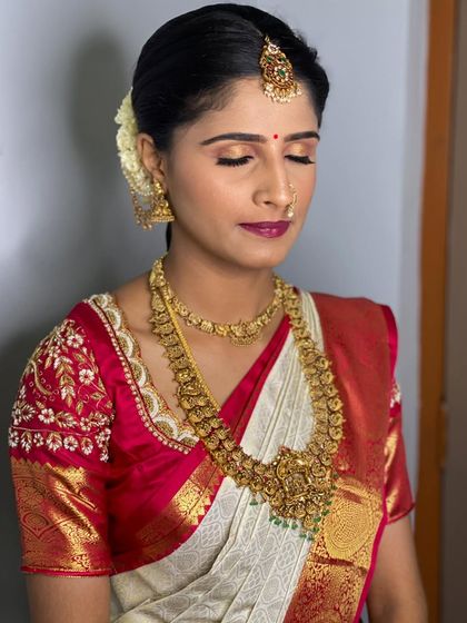 A close-up of Vathsala's makeup, showing the soft golden eyeshadow and deep berry lip color that beautifully enhances her features.