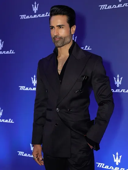 A classic black striped double-breasted suit, tailored for a sleek, modern silhouette. This is a staple for any formal wardrobe.