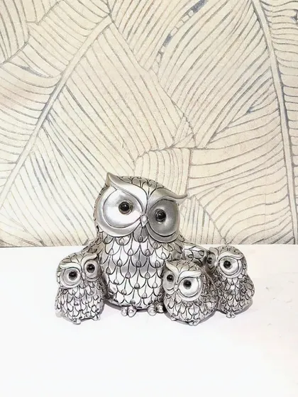 A beautiful silver-finished showpiece of a mother owl with her three owlets.