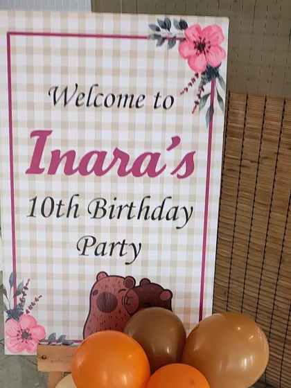 A unique and adorable Capybara-themed 10th birthday party. The welcome sign features a gingham pattern and cute illustrations to match the gentle theme.