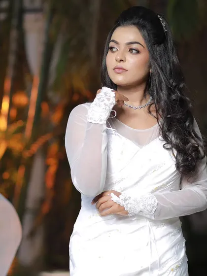 A model posing in a white gown, showcasing a modern and elegant Christian wedding look.