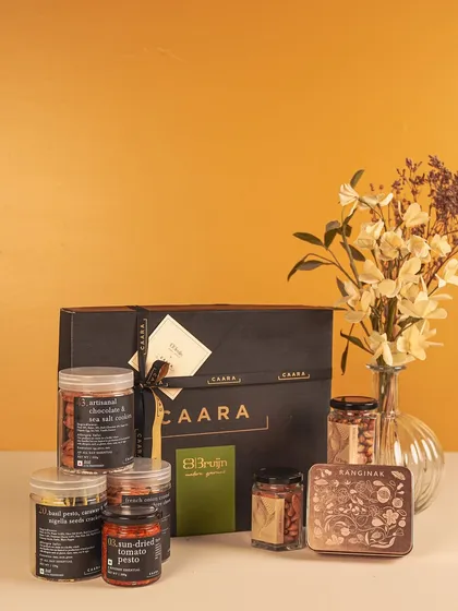 This Rakhi hamper features a selection of our savoury jars and Bruijn's gourmet treats, presented in our signature black gift box. It's a sophisticated gift that combines the best of both brands.