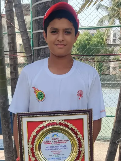 Om Verma proudly displays his winner's plaque from the Asian U-14 Grade A doubles event. Success at this level is a key indicator of a player's potential for a professional career.