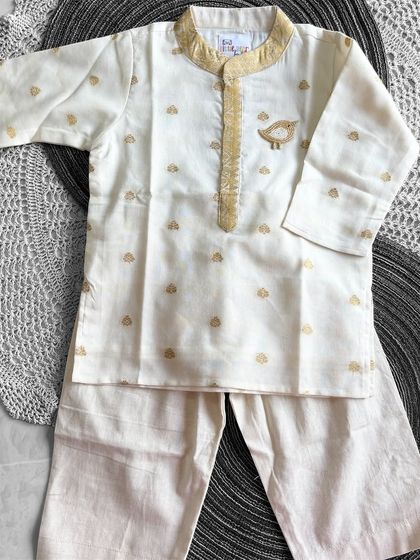 A full view of our cream kurta set with the hand-embroidered bird brooch. The soft cotton and simple design make it a comfortable choice for any special day.