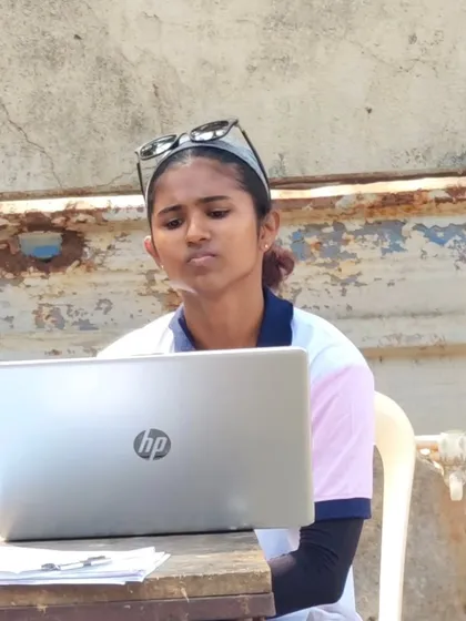 An official managing the scoring on her laptop. We use modern methods to ensure accuracy and efficiency during competitions.